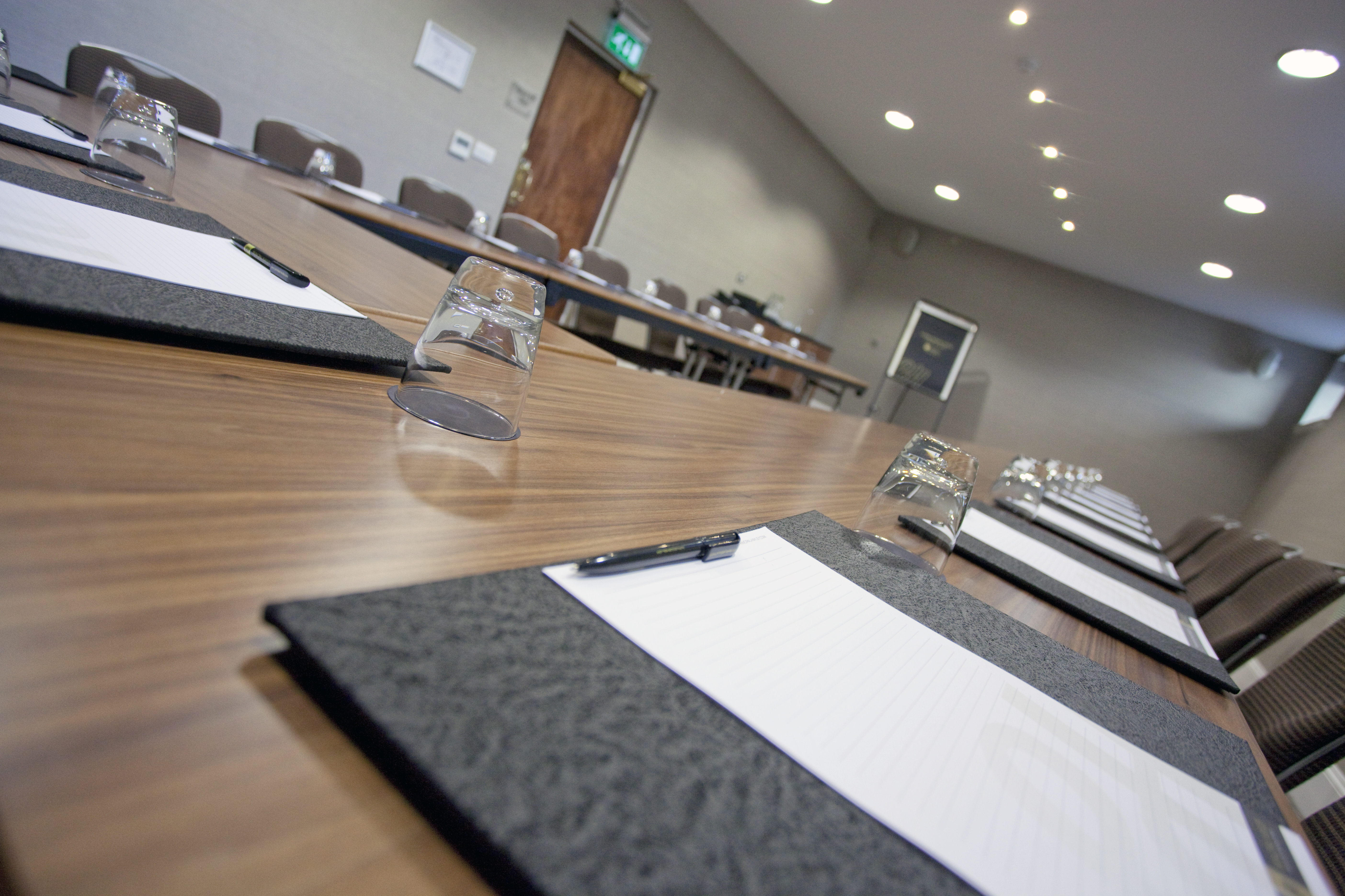 Holborn Suite meeting room with long table, notepads for professional workshops.