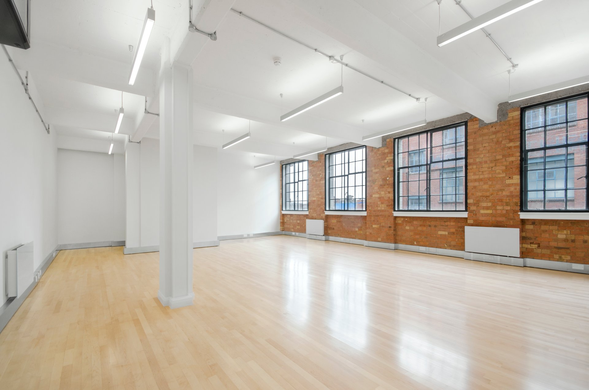 Spacious Mezzanine event space with large windows, ideal for meetings and workshops.