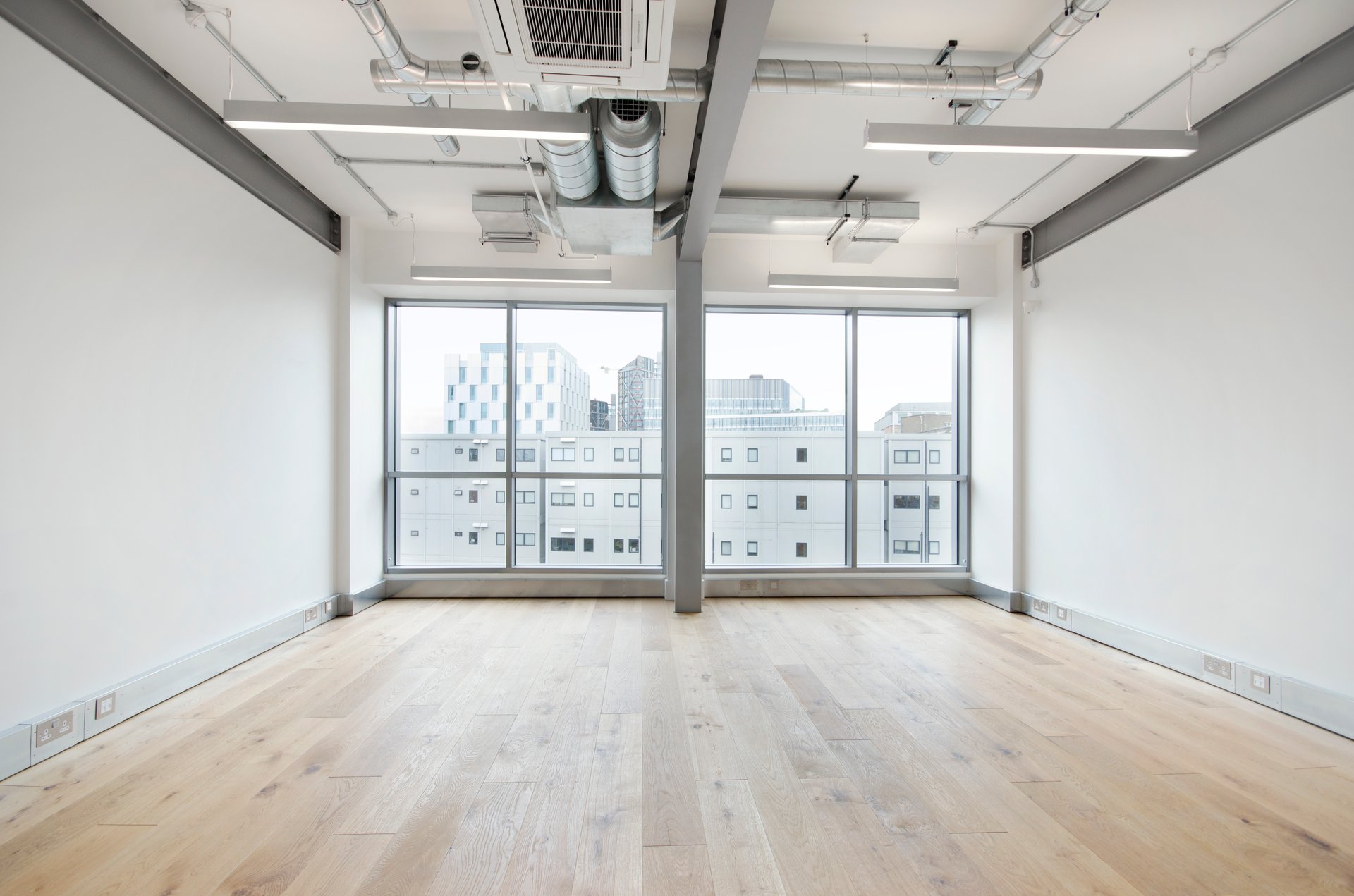 Spacious meeting room with city view, ideal for workshops and events.