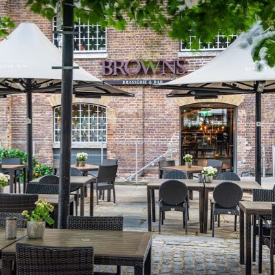 Outdoor dining at Cellar Bar, stylish terrace with umbrellas for networking events.