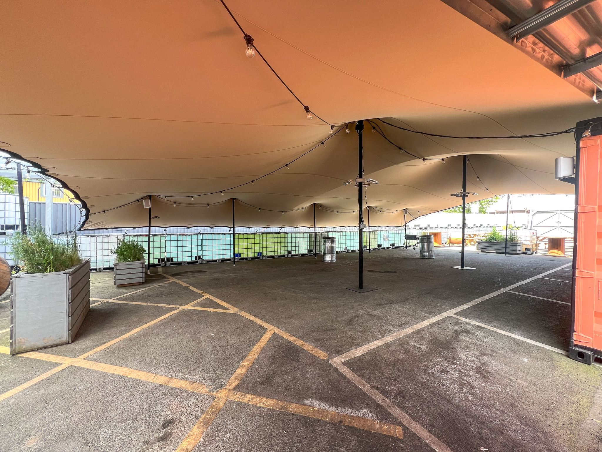 Versatile outdoor event space with canopy, ideal for gatherings and film events.