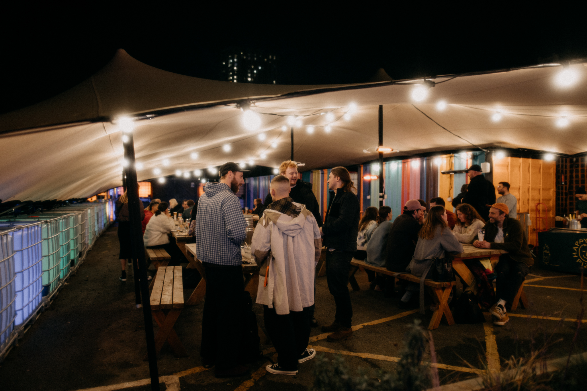 Outdoor event space with string lights, perfect for social gatherings and networking.