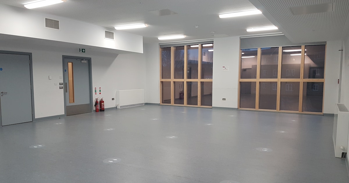 Versatile empty event space in Tarling East Community Centre, ideal for meetings and workshops.