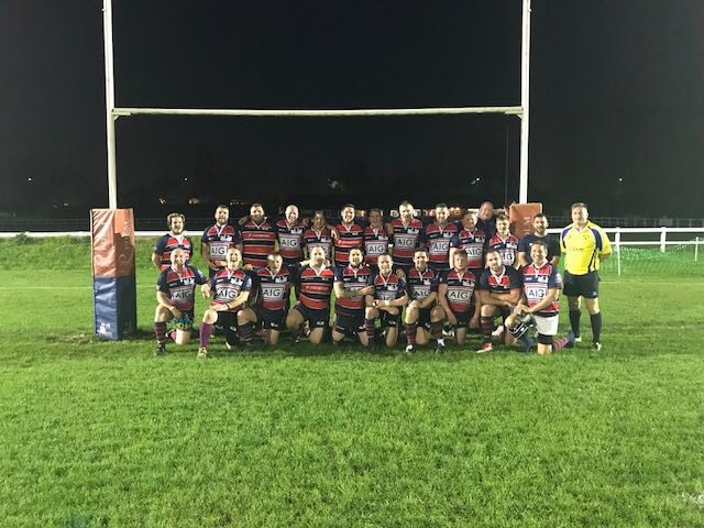 Rugby team celebrating camaraderie on Staines Rugby Club field, ideal for sports events.