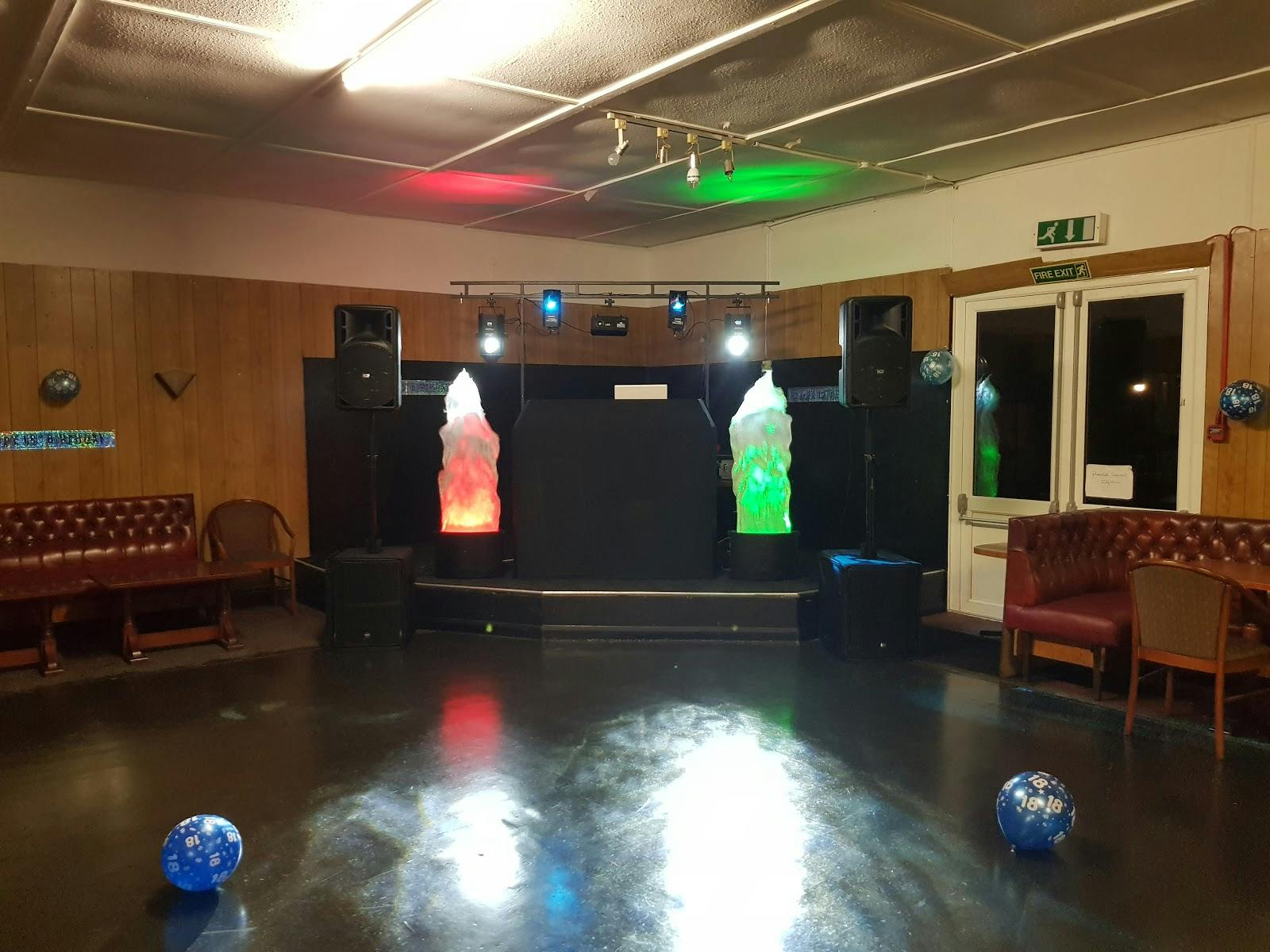 Versatile event space at Staines Rugby Club with stage, ideal for parties and presentations.