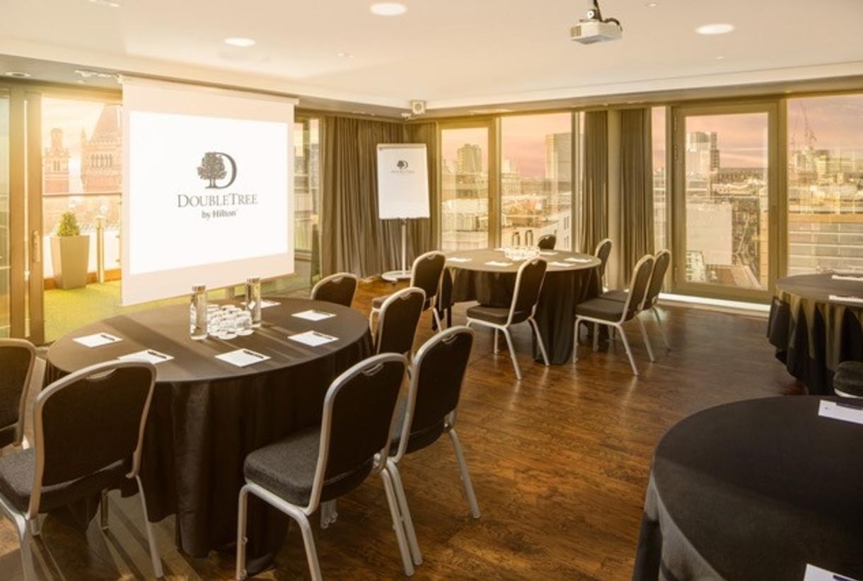 Conference room at DoubleTree by Hilton Manchester with round tables, ideal for workshops.
