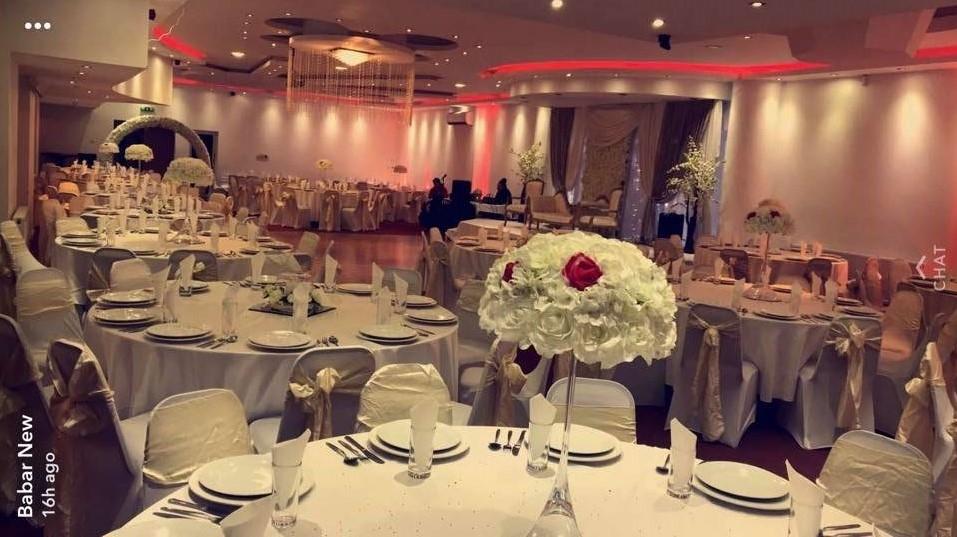 Elegant banquet hall with white linens, ideal for weddings and formal events.