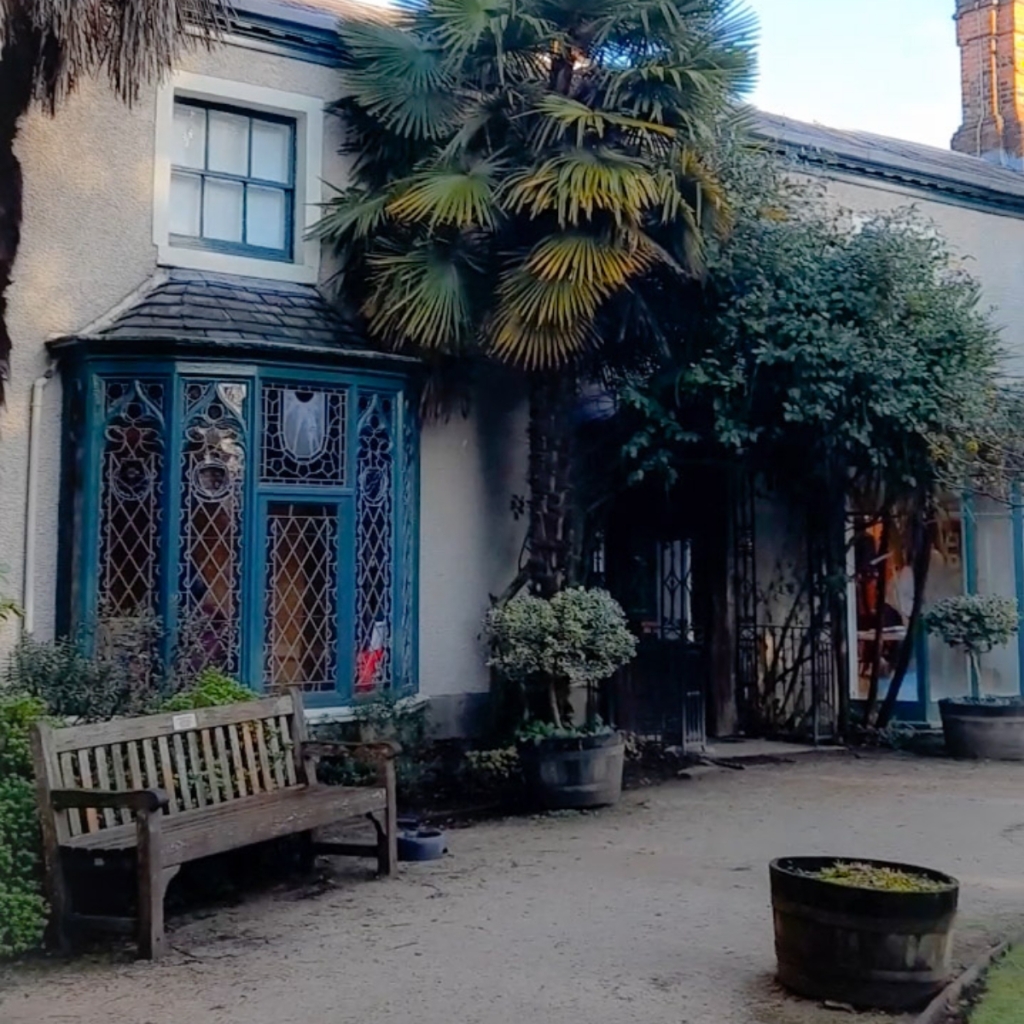 Art exhibits at Didsbury Parsonage Trust with stained glass and lush greenery for events.