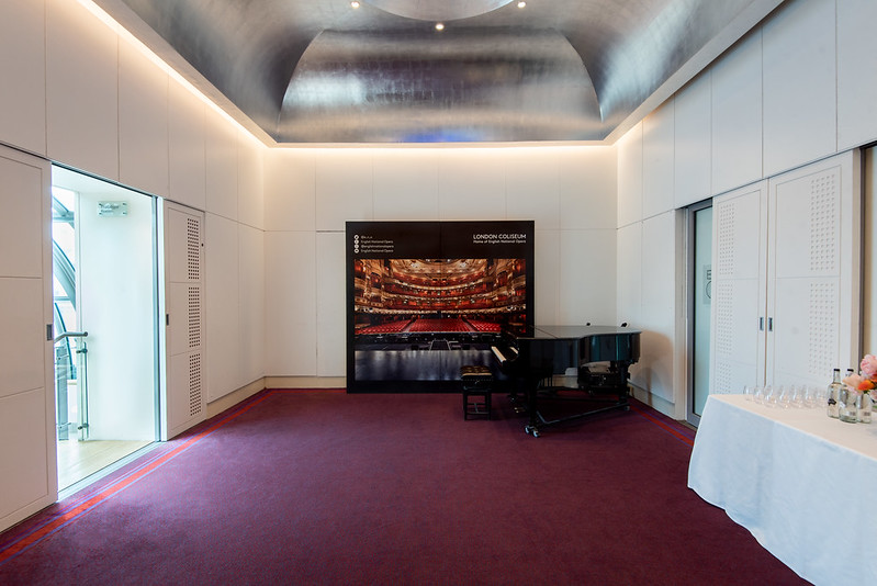 Elegant meeting space in London Coliseum with grand piano, perfect for corporate events.