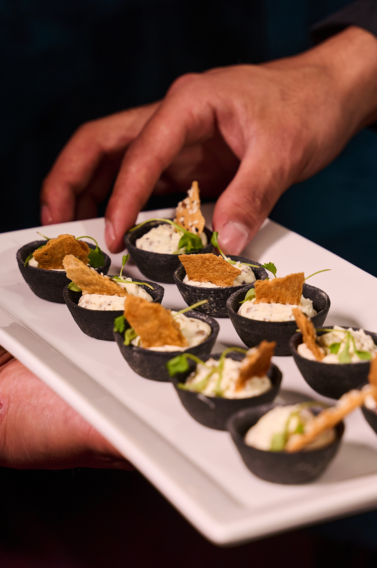 Gourmet appetizers in black cups at The Clore Space, perfect for networking events.