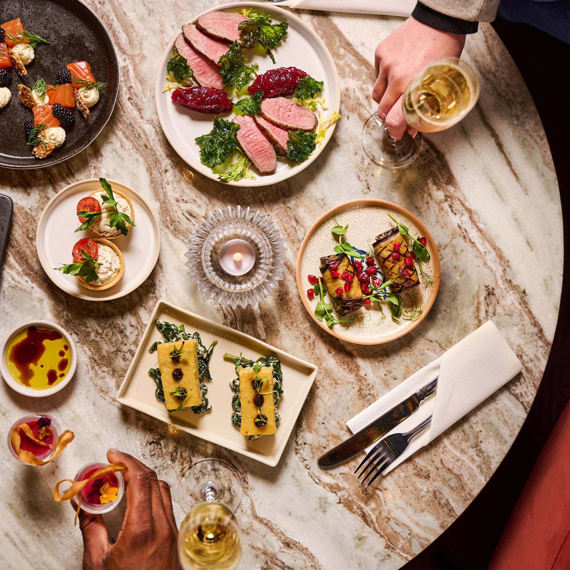 Elegant table setting with gourmet dishes for corporate events in London Coliseum.