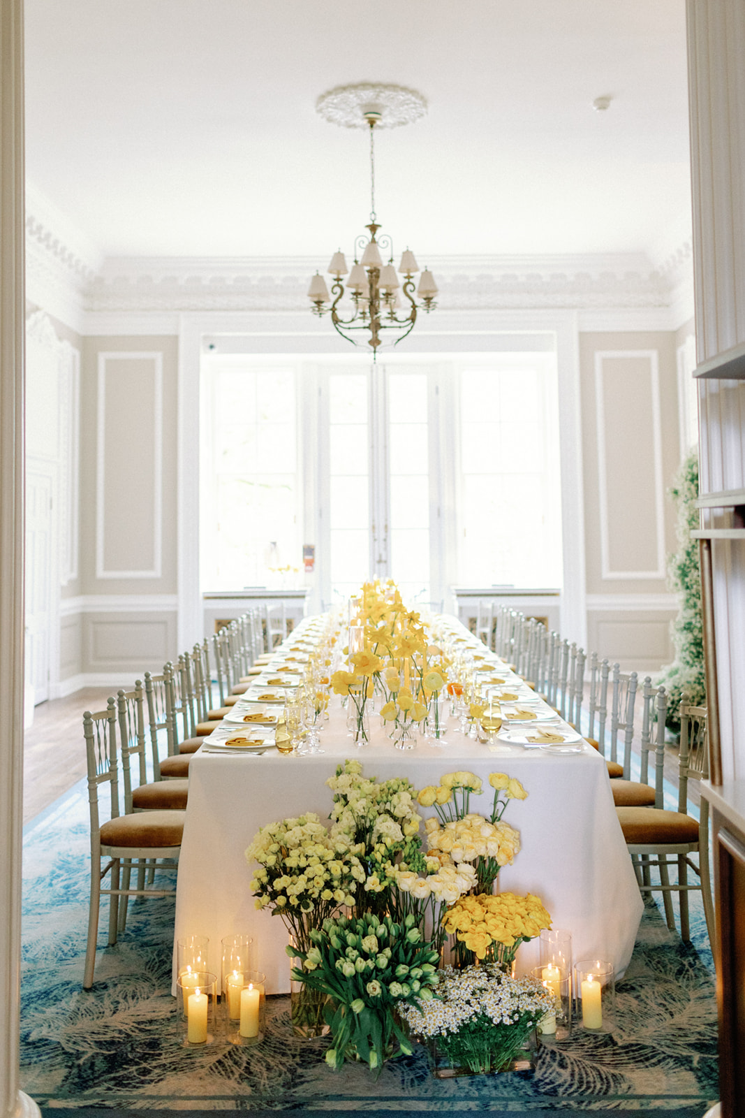 Elegant long table with yellow flowers in Brabourne Room for sophisticated events.