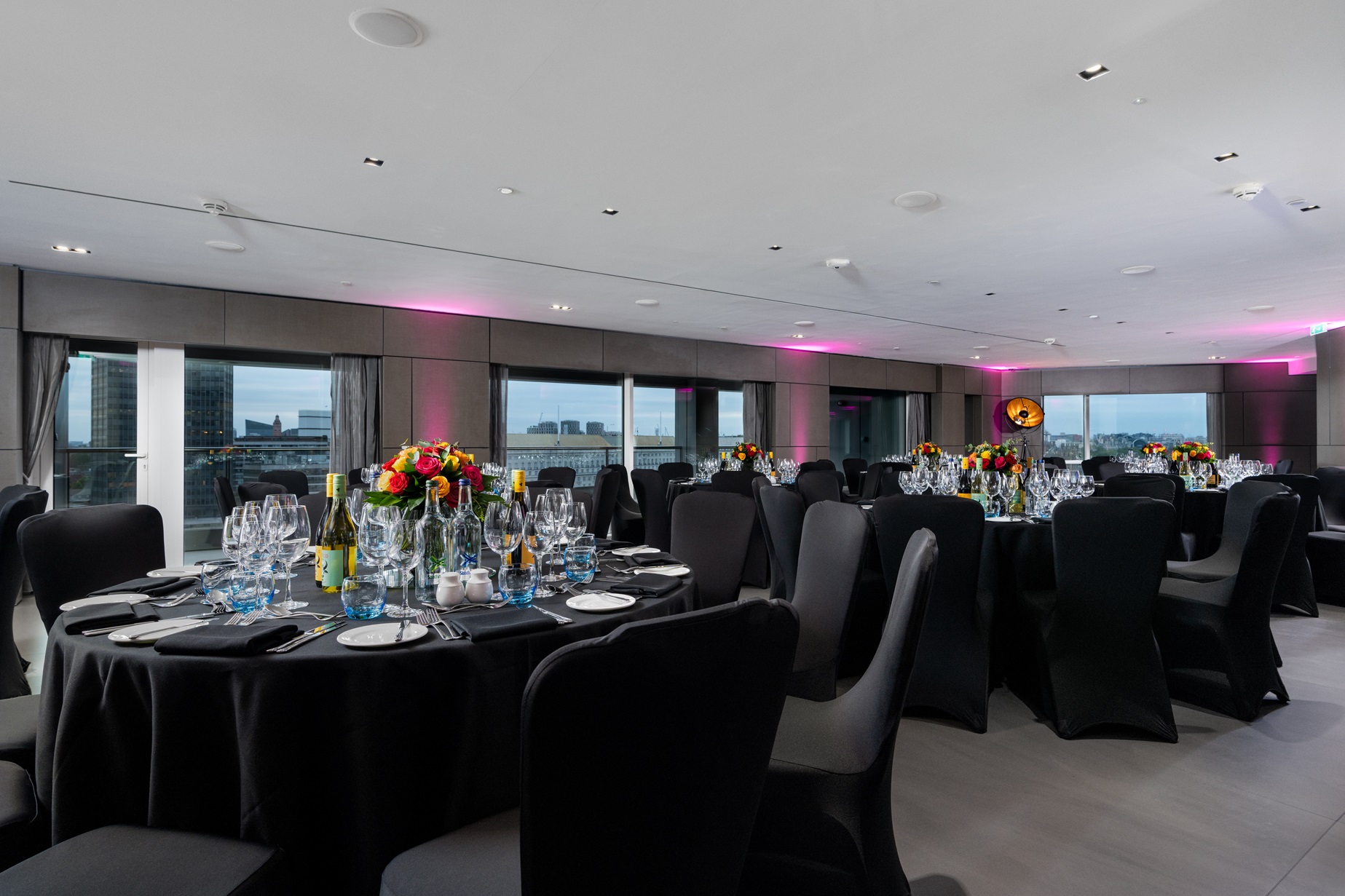 Elegant dinner setup at Riverview Lounge, Park Plaza London Riverbank with floral centerpieces.