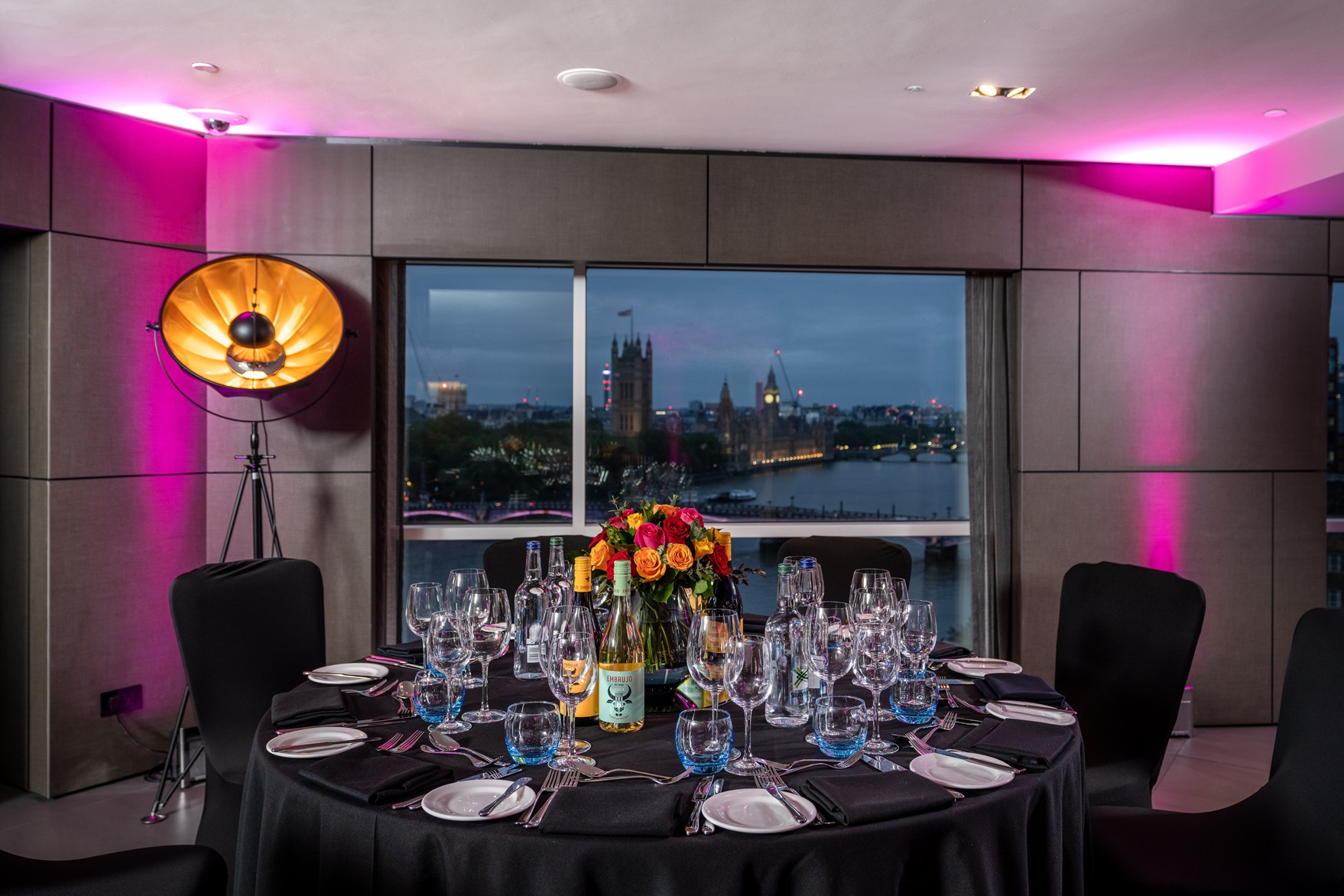 Elegant round table setup in Riverview Lounge, perfect for upscale dinners and corporate events.