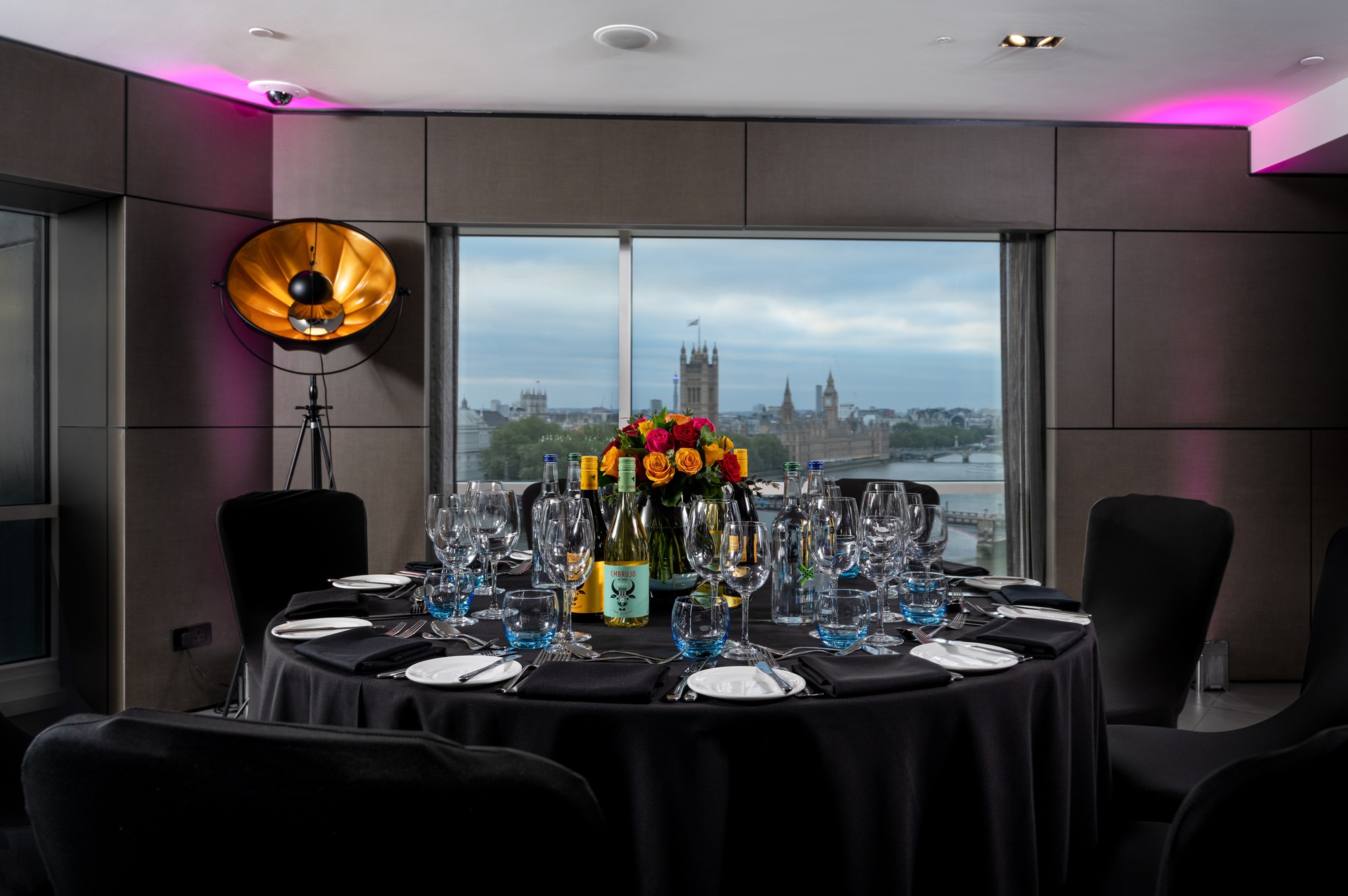 Riverview Lounge event setup with elegant table, floral centerpieces, and city skyline.