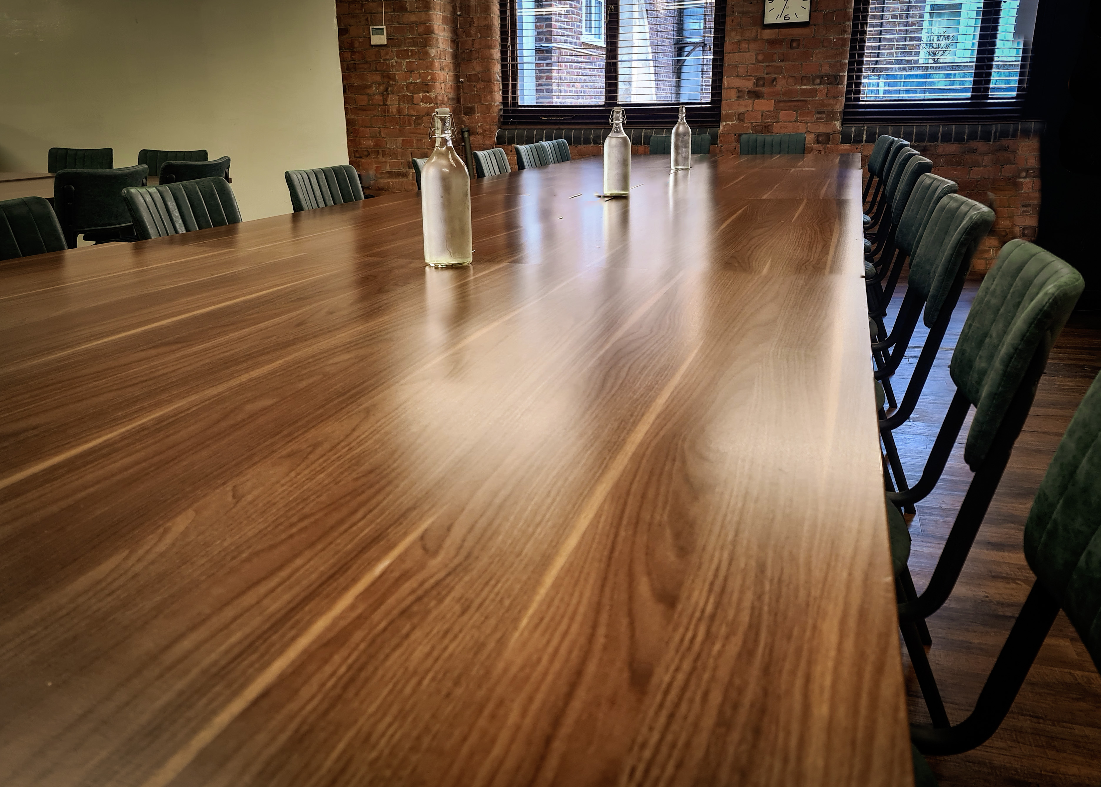 Modern Yellow Room conference setup with wooden table, ideal for meetings and events.