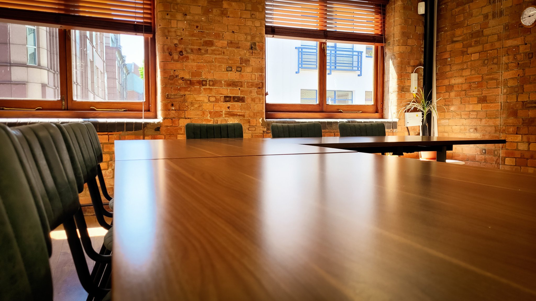 Modern Purple Room with wooden table, ideal for meetings and events.