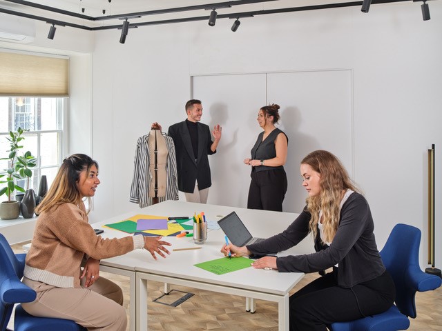 Collaborative design studio meeting for fashion and event styling brainstorming.