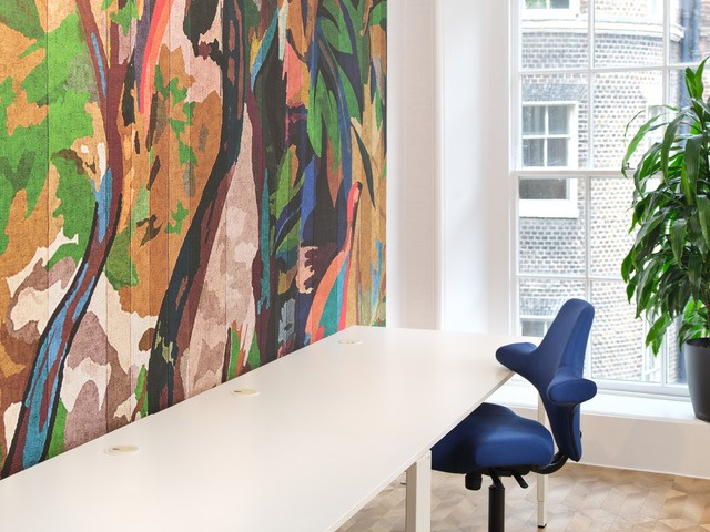 Modern meeting space in RSA House with vibrant mural, ideal for brainstorming sessions.