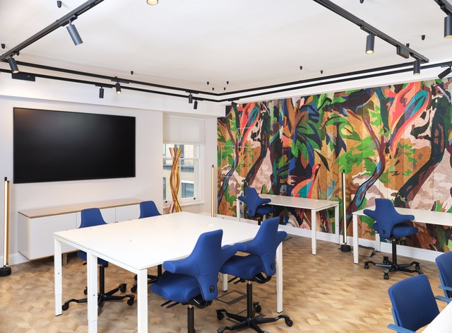 Modern meeting space in RSA House with vibrant mural, ideal for workshops and brainstorming.