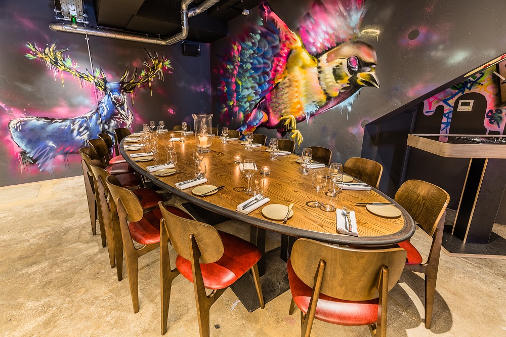 Hidden Heddon dining space with mural art, perfect for corporate events and gatherings.