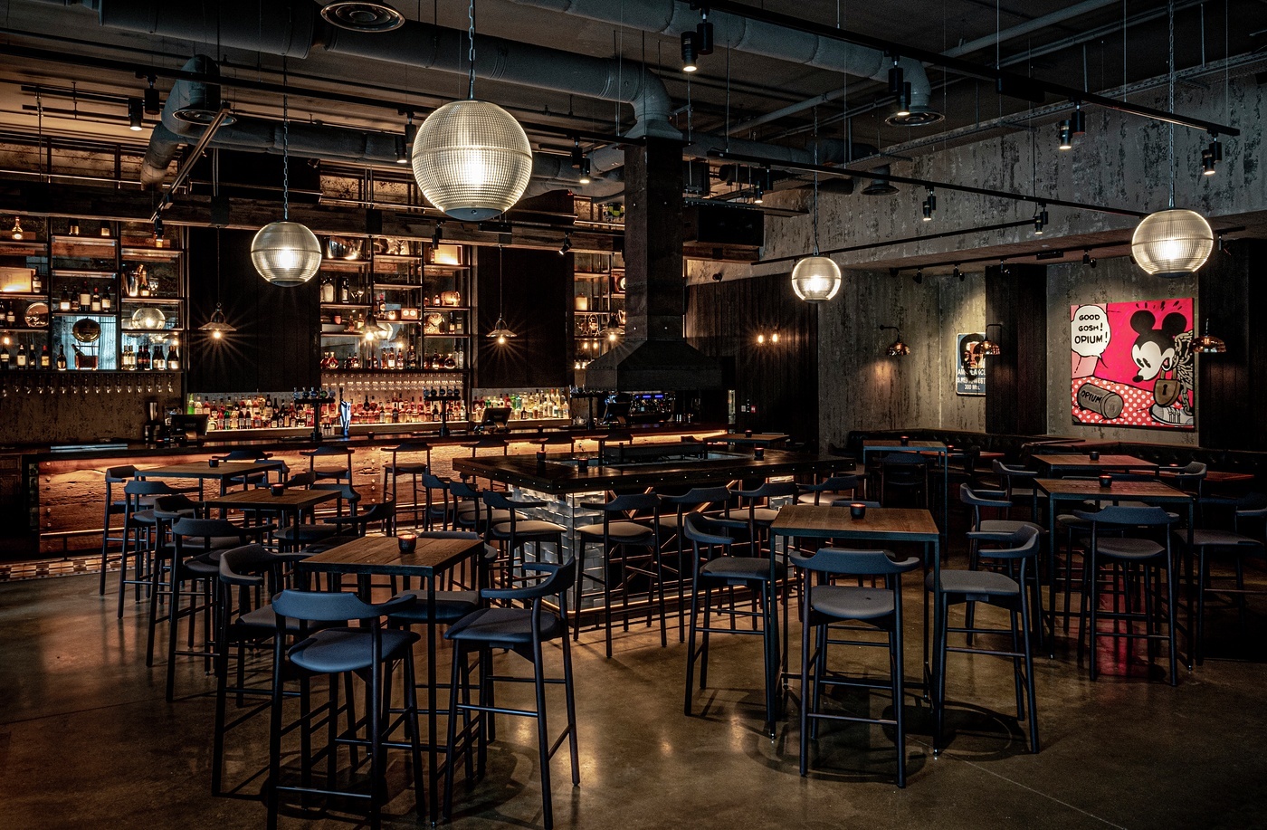 Modern event venue with high-top tables at Bread Street Kitchen, ideal for gatherings.