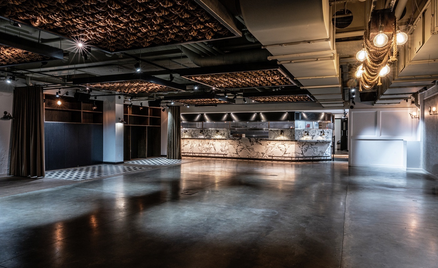 Modern event space with polished concrete floors for corporate meetings and social gatherings.
