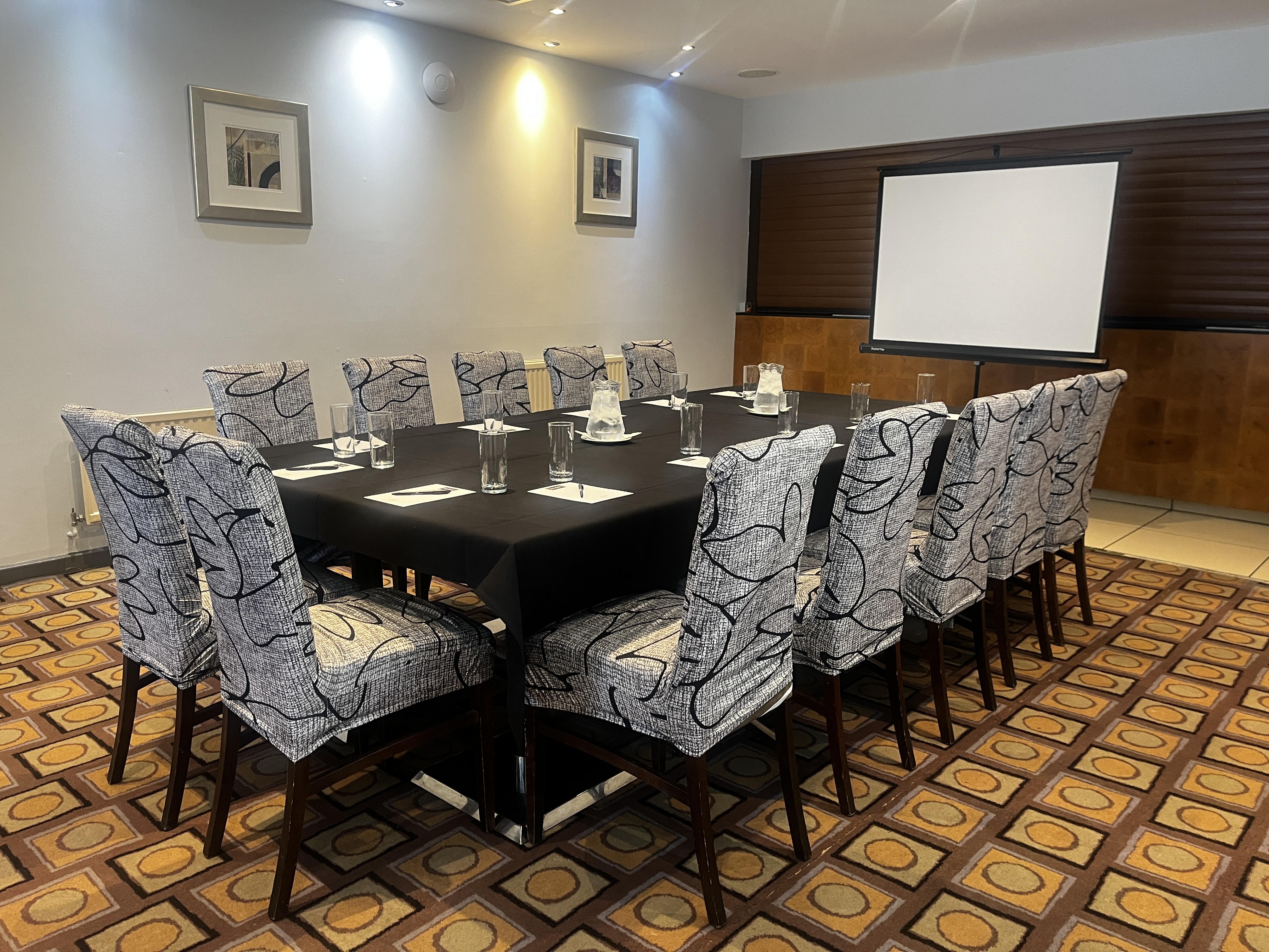 Meeting room at The Stuart Hotel with a rectangular table, perfect for professional gatherings.