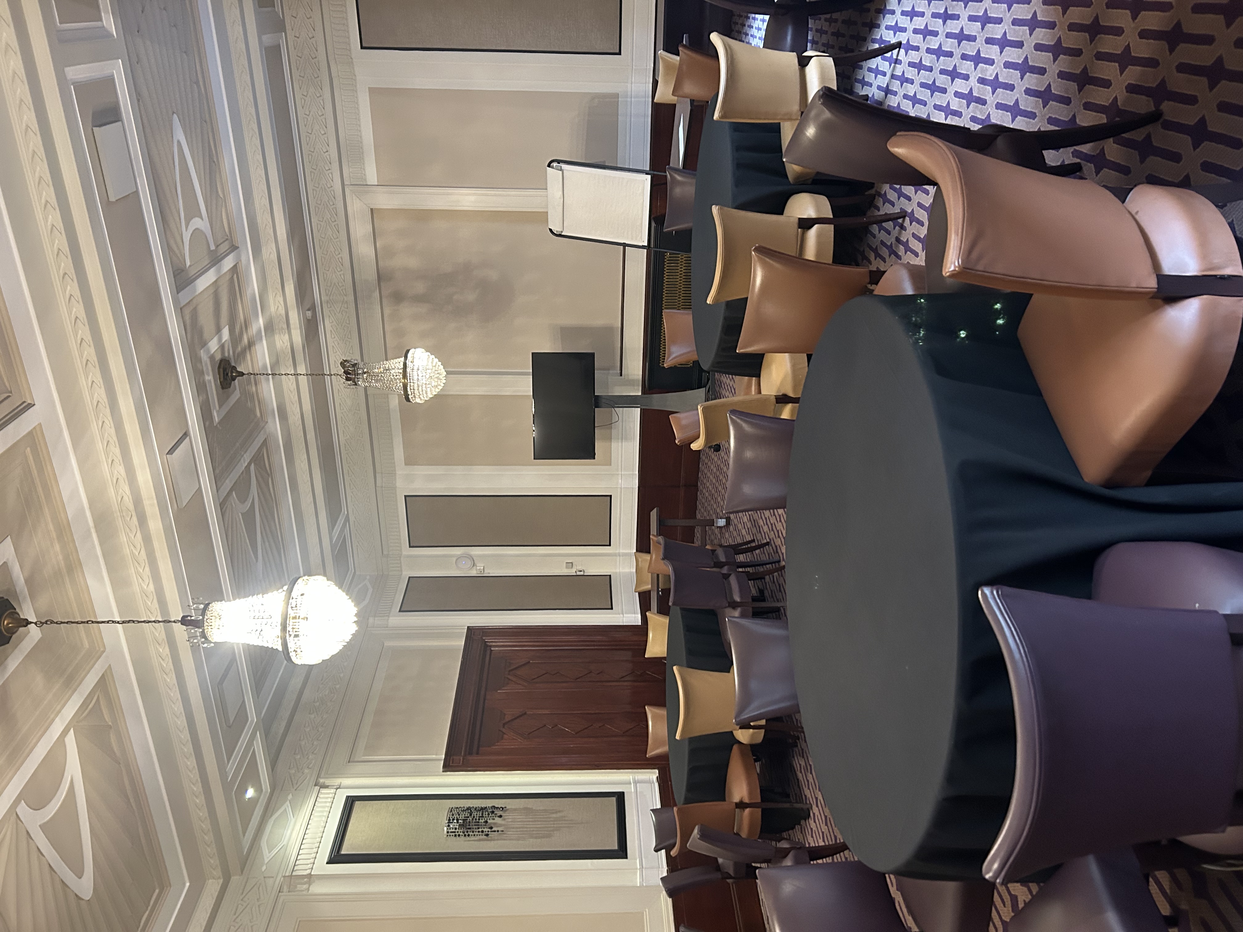 Private dining suite with round tables, ideal for workshops and conferences.