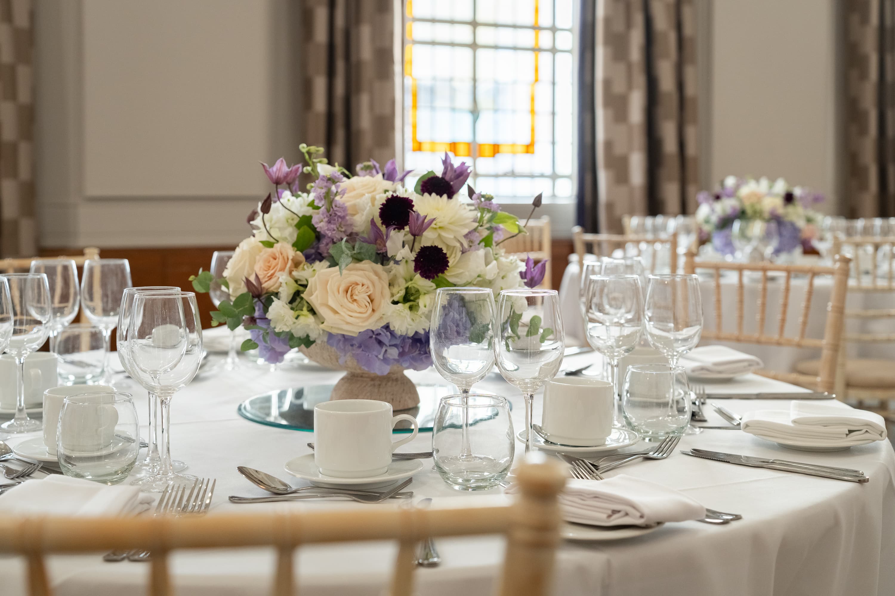 Cambria Suite banquet setup with elegant floral centerpieces for formal corporate events.
