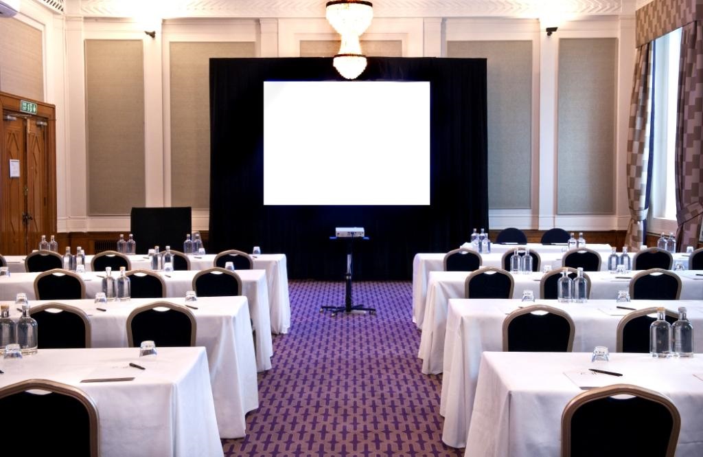Cambria Suite meeting room with tables, notepads, ideal for corporate events and workshops.