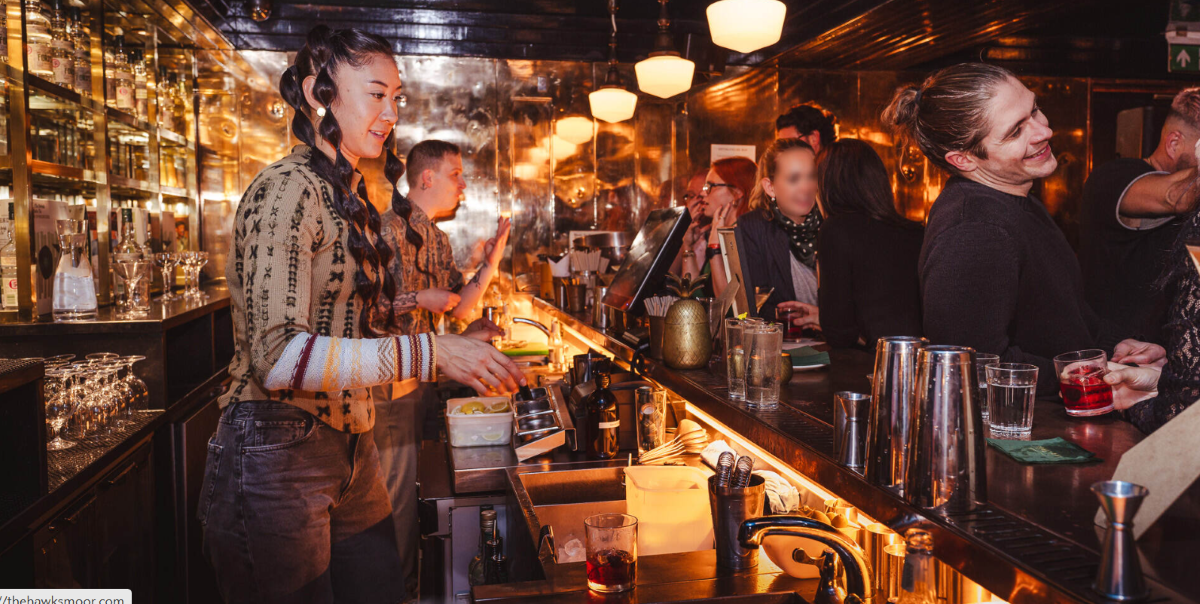 Vibrant bar scene at Hawksmoor Spitalfields for networking events and social gatherings.