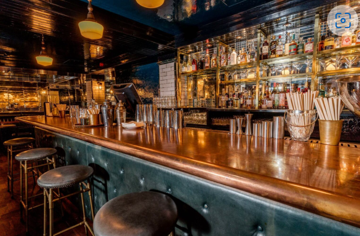 Stylish bar with polished wood counter at Hawksmoor Spitalfields for events and receptions.