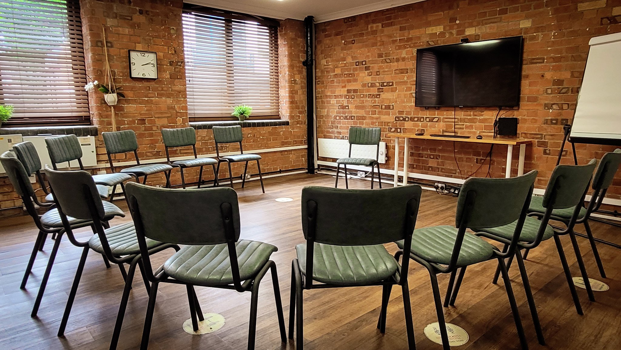 Green Room at Remark! Events: inviting meeting space with circular seating for workshops.