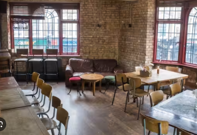 Cozy Chloë's Basement Bar with warm brick walls, perfect for informal meetings and gatherings.