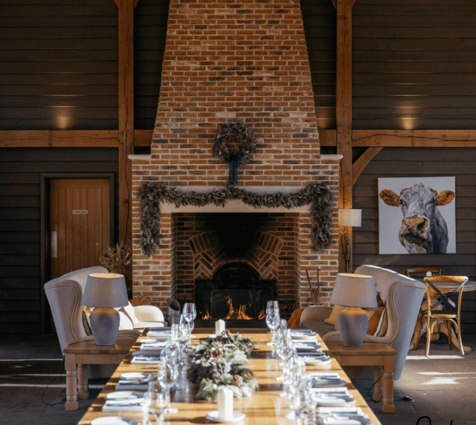 Cozy event space with rustic fireplace, ideal for retreats and gatherings.