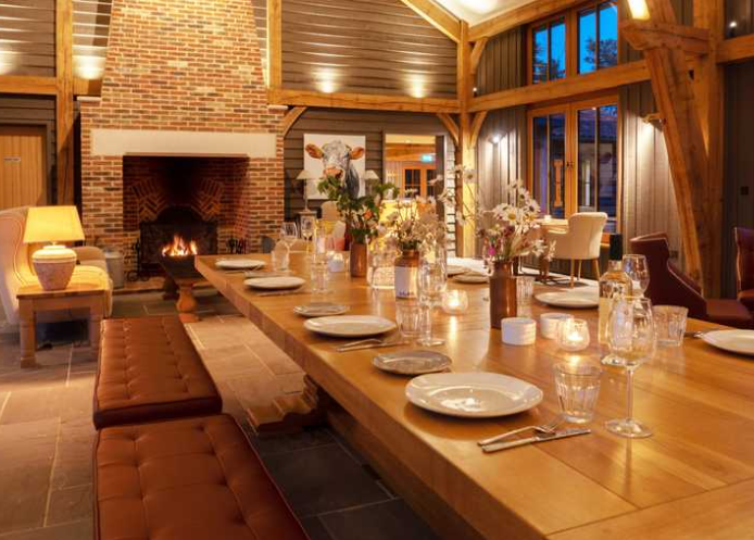 Elegant dining space with wooden table, perfect for corporate retreats and intimate gatherings.