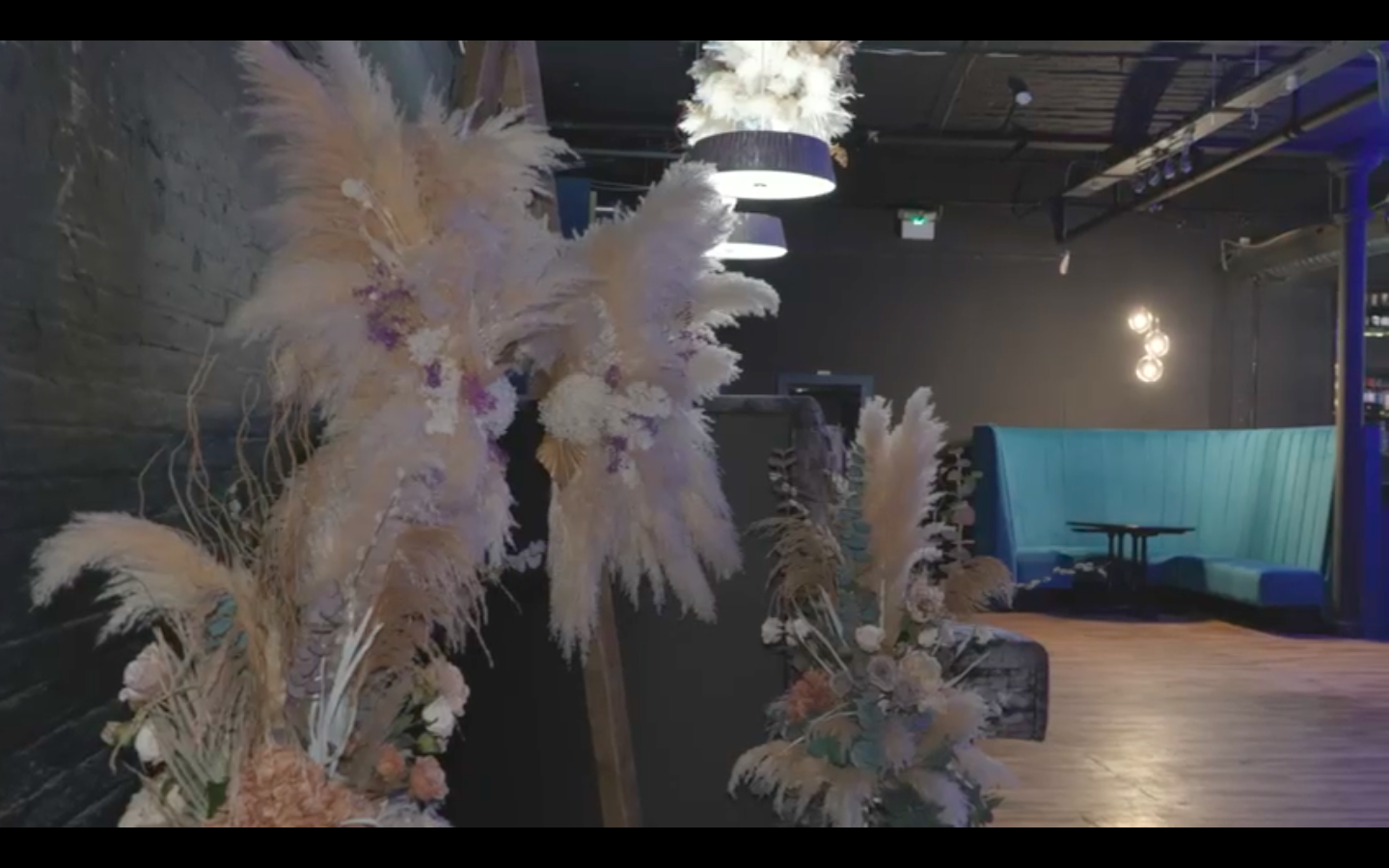 Stylish event space with elegant floral arrangements for intimate gatherings and networking.