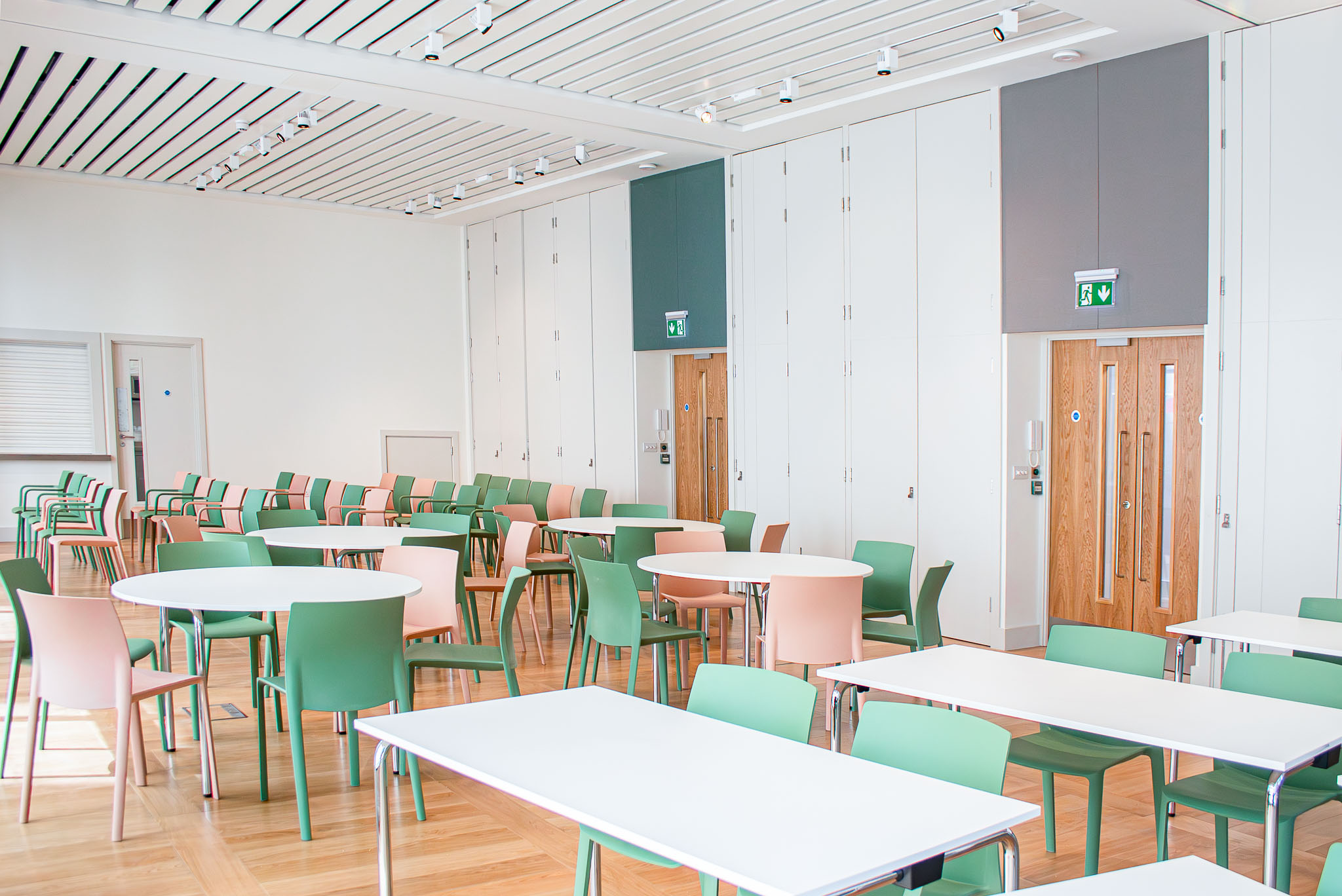 Versatile event space in The Aldgate Centre with colorful chairs for workshops and networking.