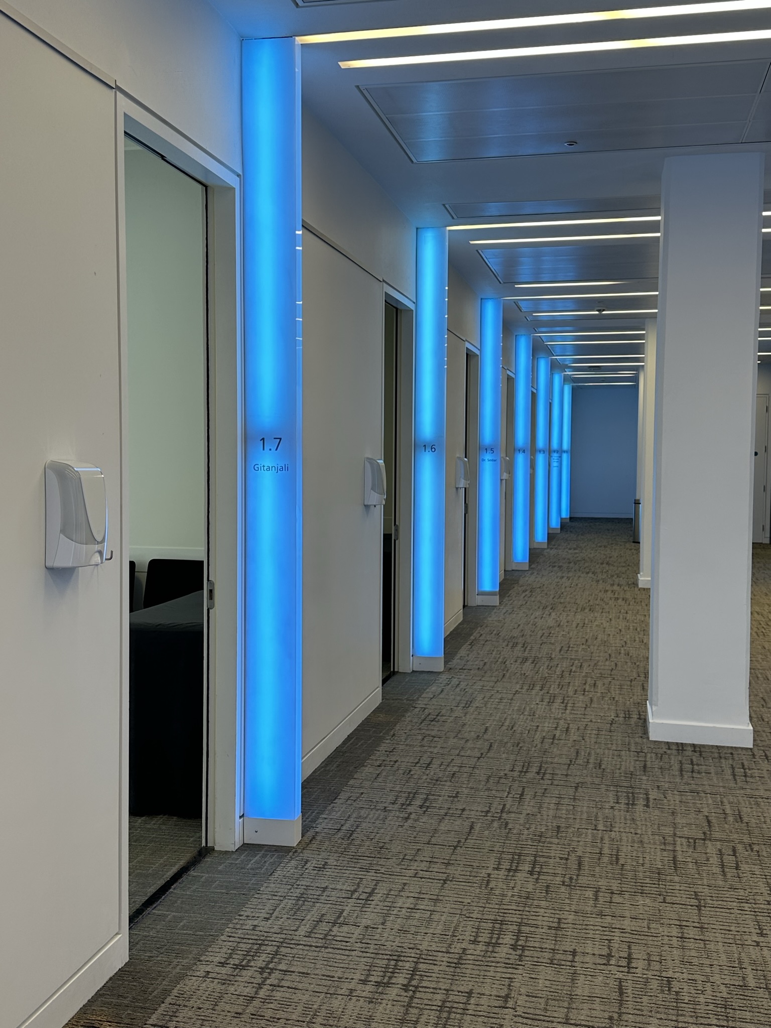 Modern corridor at Scenario Assessment Centre with blue lighting, ideal for corporate events.