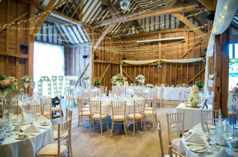 Tythe Barn Tewin Bury Farm wedding venue with rustic beams and elegant decor.
