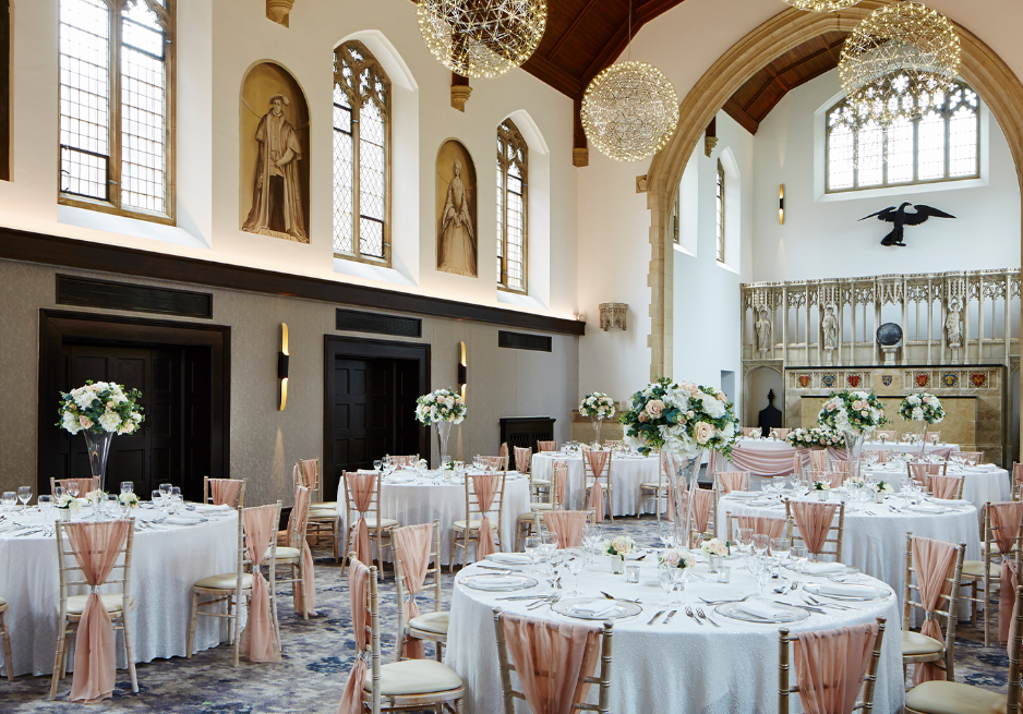 Elegant Poles Hall at Hanbury Manor, ideal for weddings with high ceilings and floral decor.