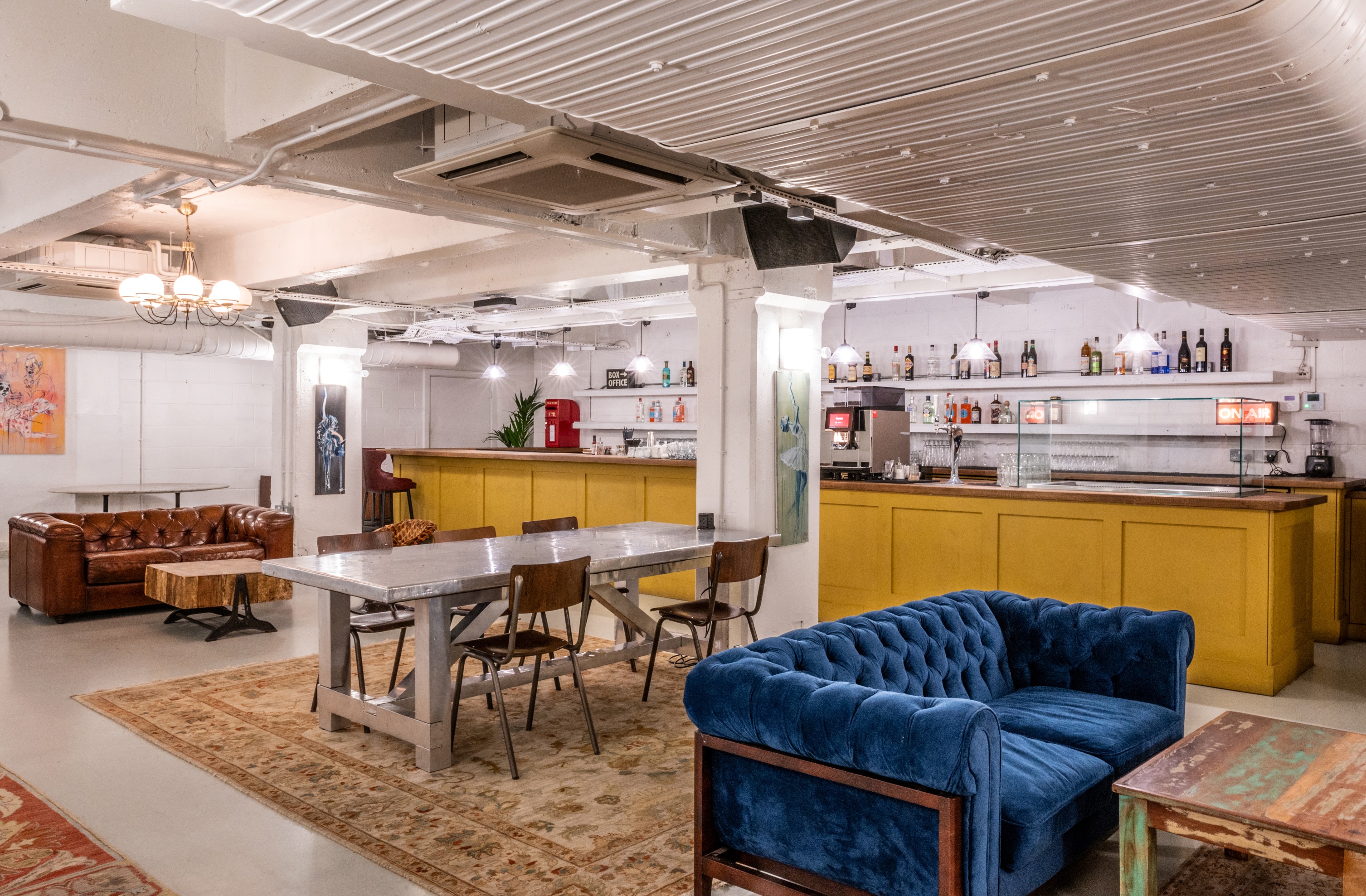 Versatile event space at Pizza East with stylish blue couch for networking and gatherings.