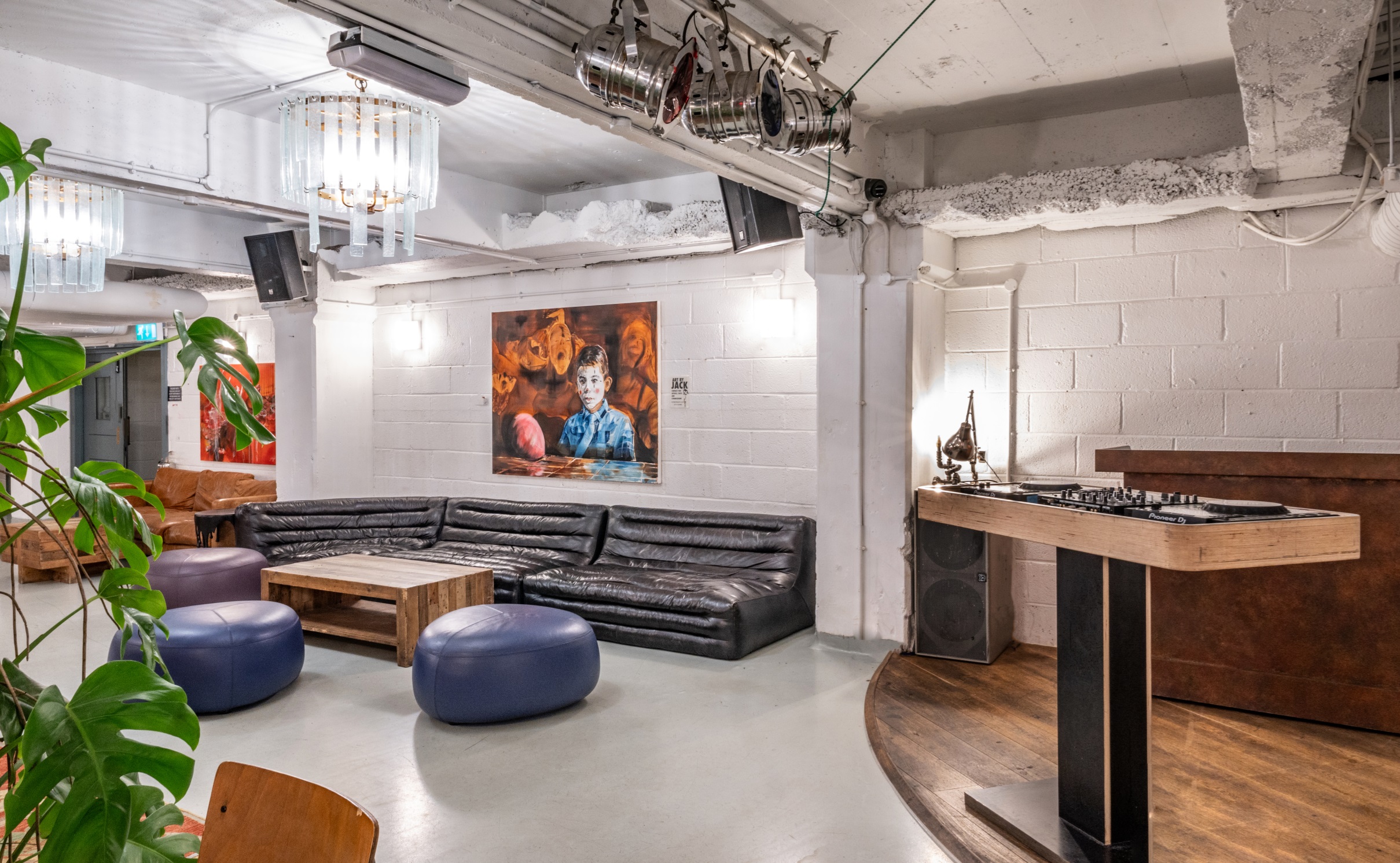 Versatile event space at Pizza East with stylish lounge and DJ setup for gatherings.