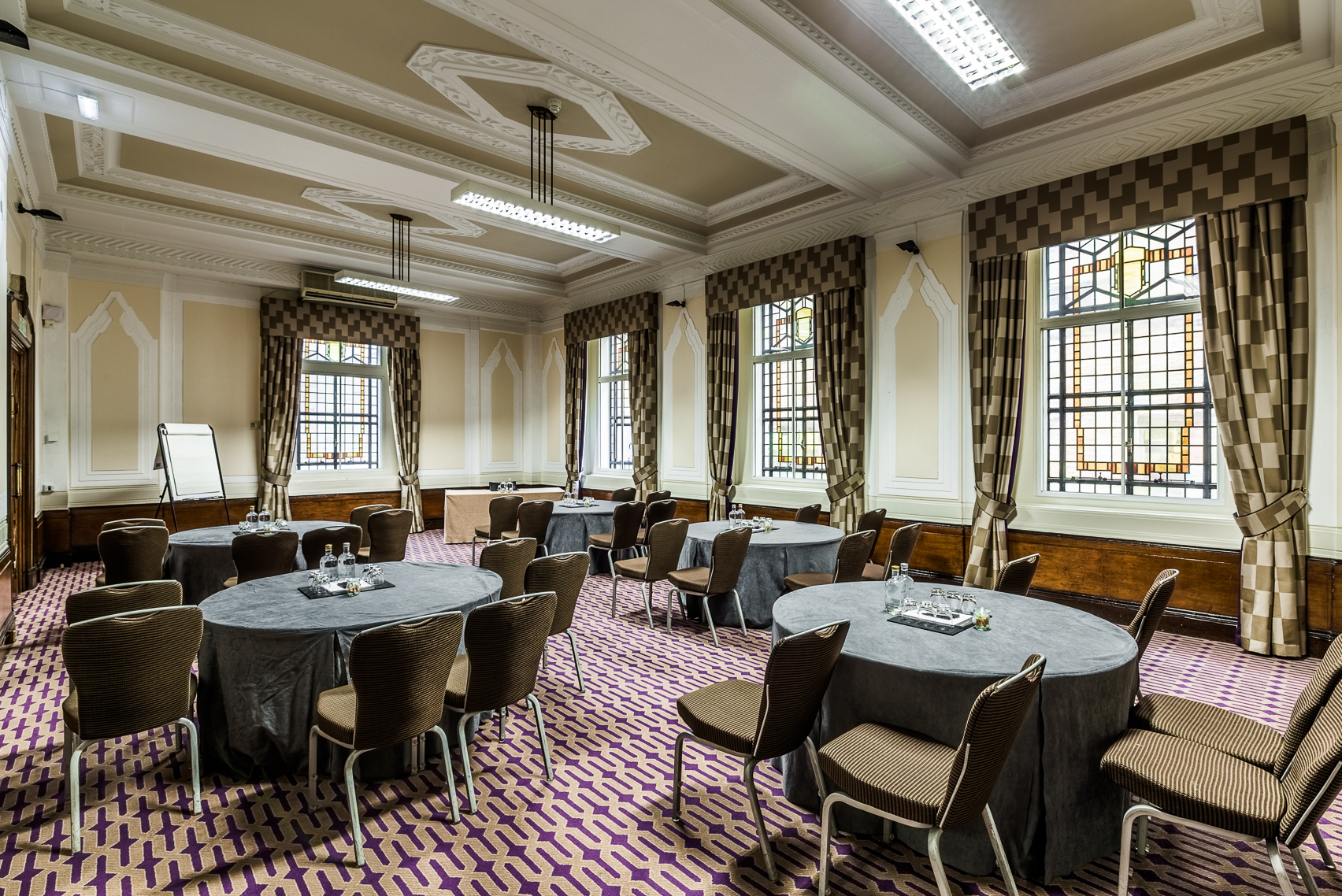 Ulster Suite meeting room with round tables, perfect for workshops and conferences.