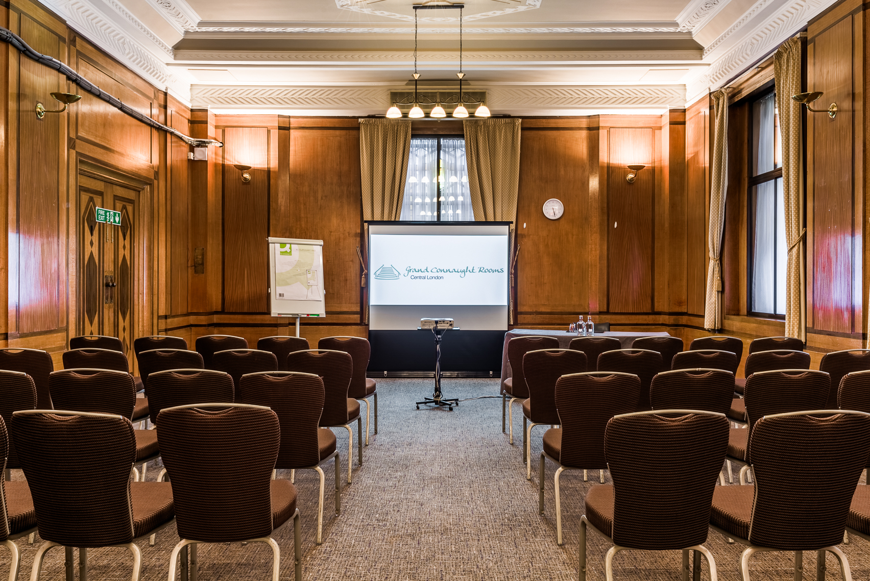 Essex Suite meeting room with brown chairs, projector screen for professional events.