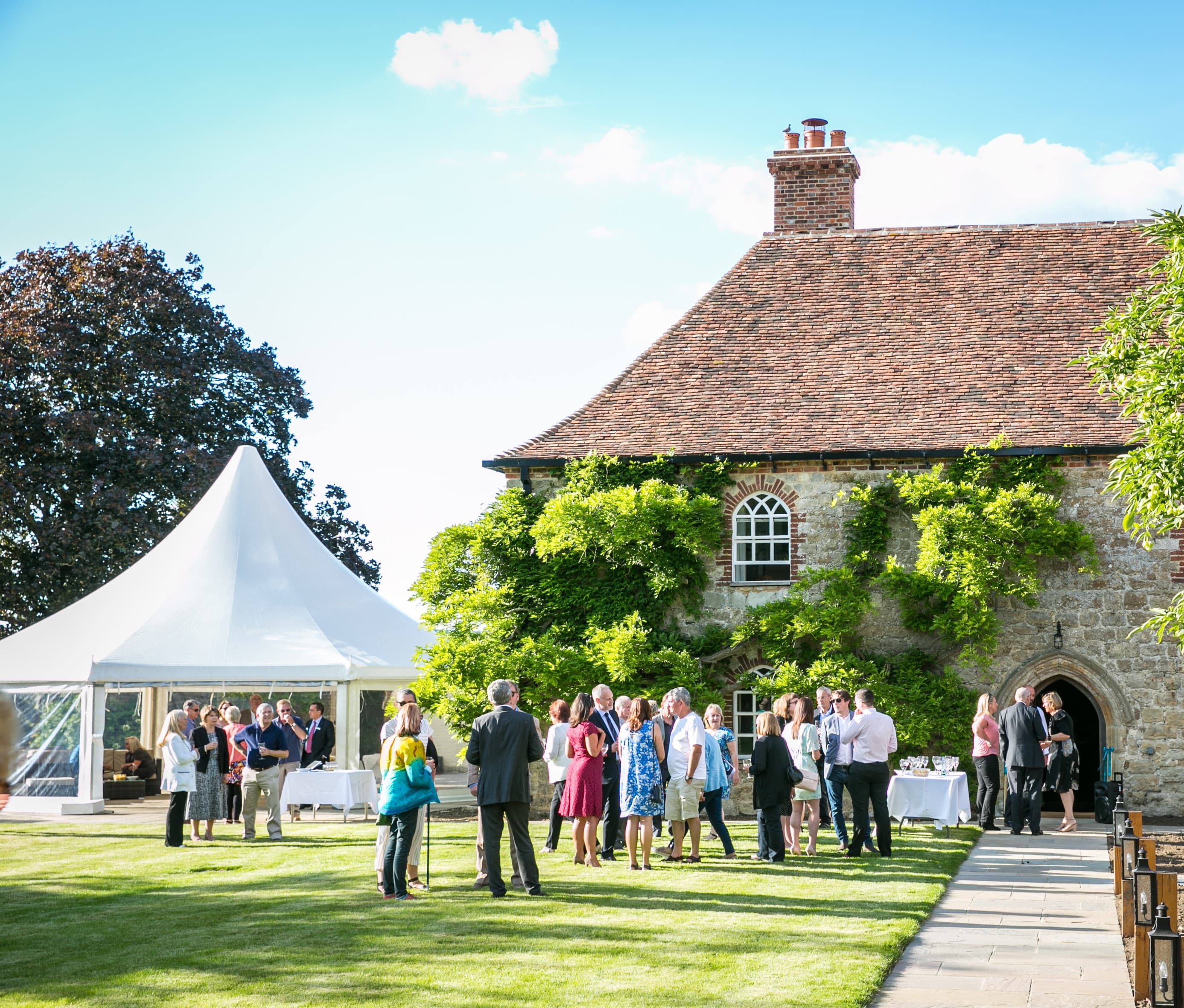 Battel Hall Leeds Castle: High-peak marquee garden reception venue for luxury weddings.