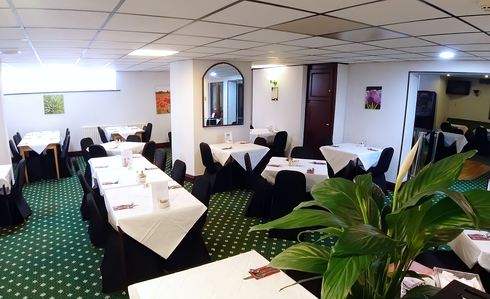Elegant Meeting Room 1 at Bluewaters Hotel with white tablecloths for events.
