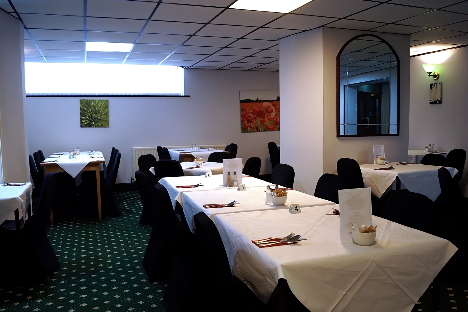 Elegant dining space in Bluewaters Hotel for meetings and events with natural light.