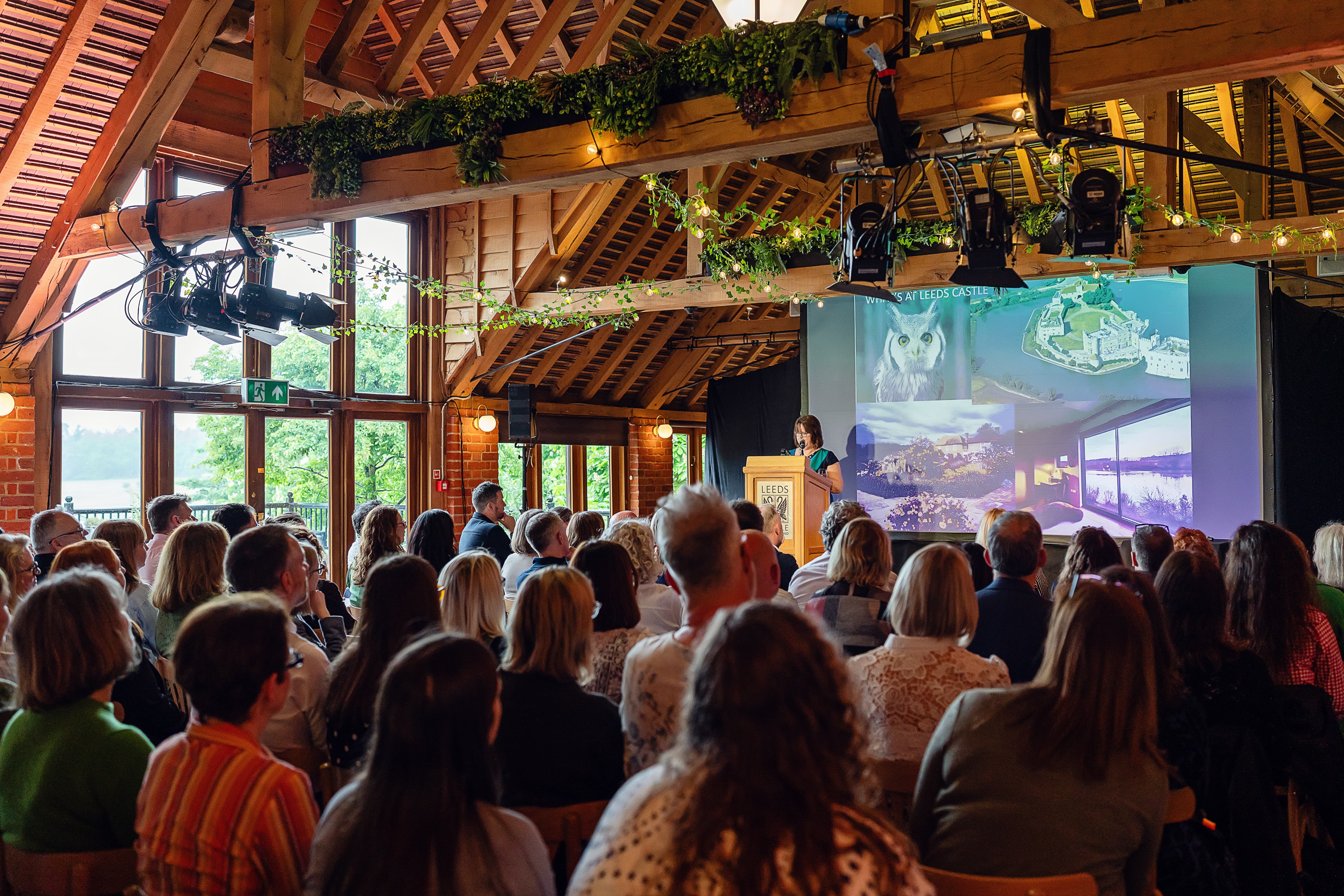 Corporate presentation at Fairfax Barn Leeds Castle, featuring rustic charm and theatre seating.